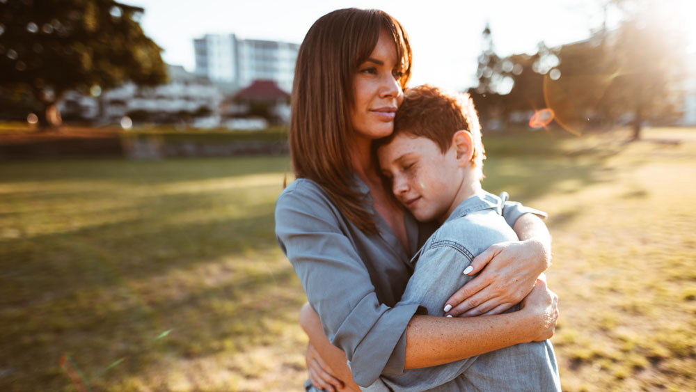 Woman and son hugging