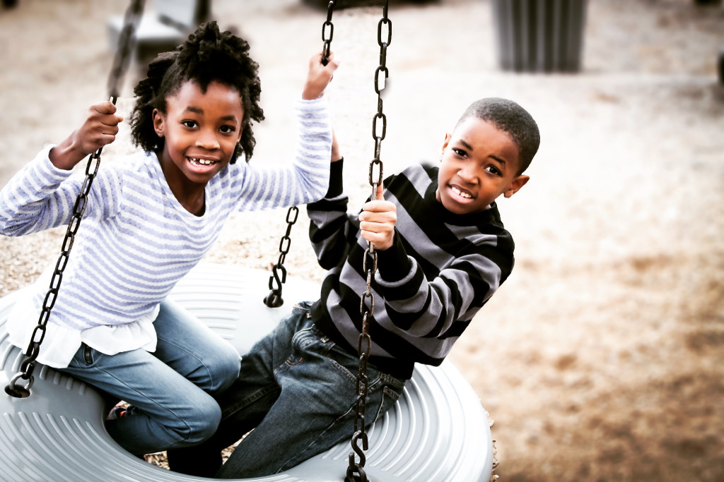 2 kids on a swing