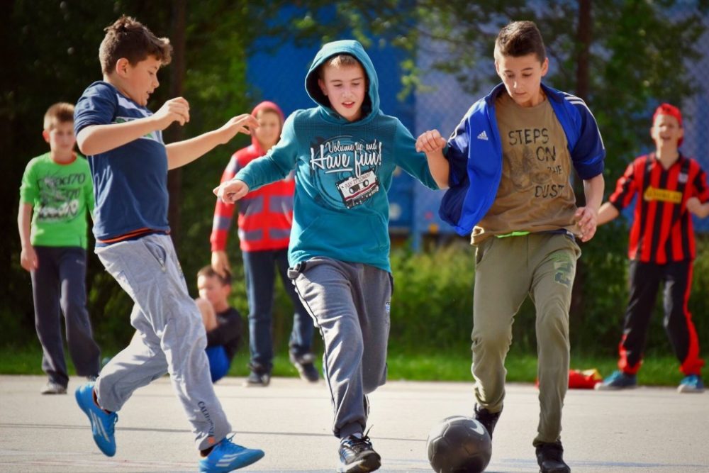 Kids playing soccer in their neighborhood