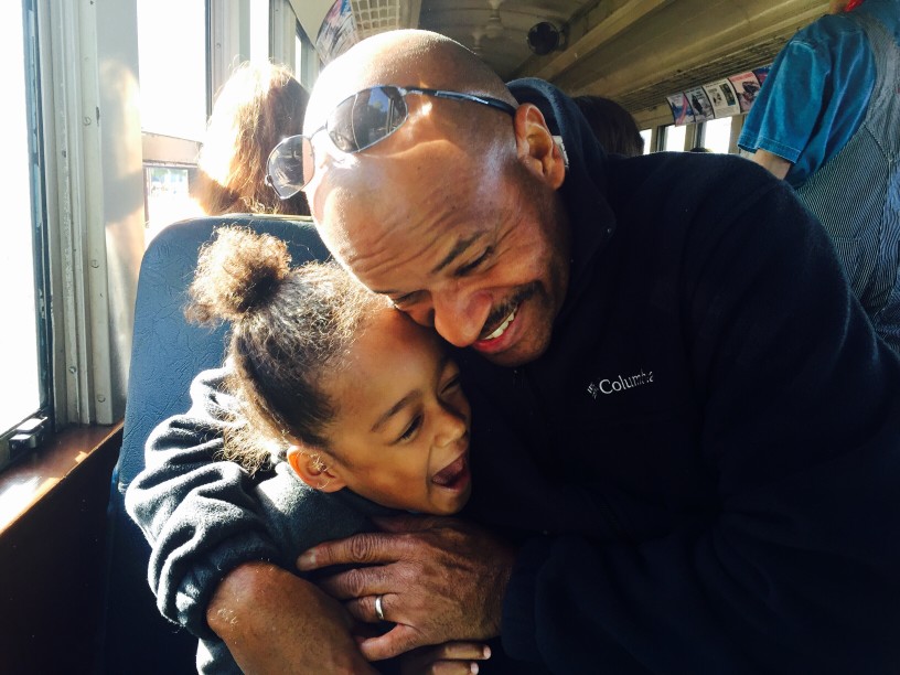 Dad holding daughter keeping her safe