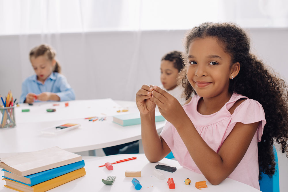 Smiling confident girl in classroom